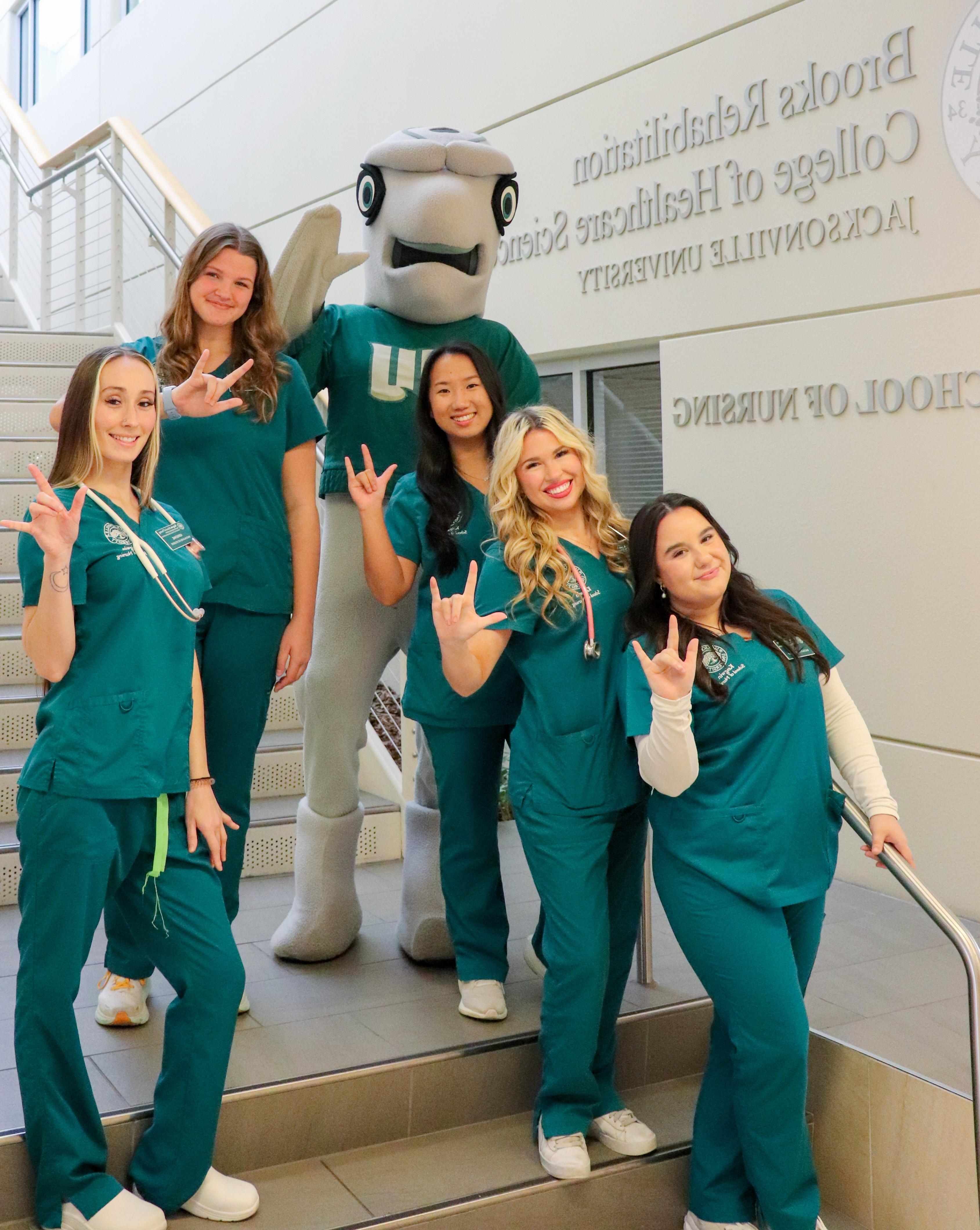 Students on stairs with mascot